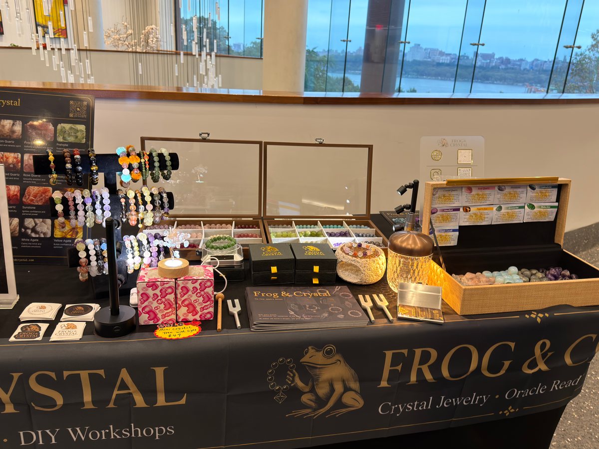 Bracelets and products on a Frog & Crystal branded display table.